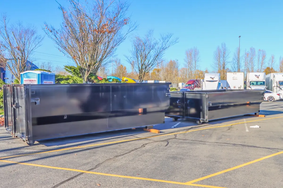 Professional dumpster rental service with roll-off container on residential driveway in Longmeadow